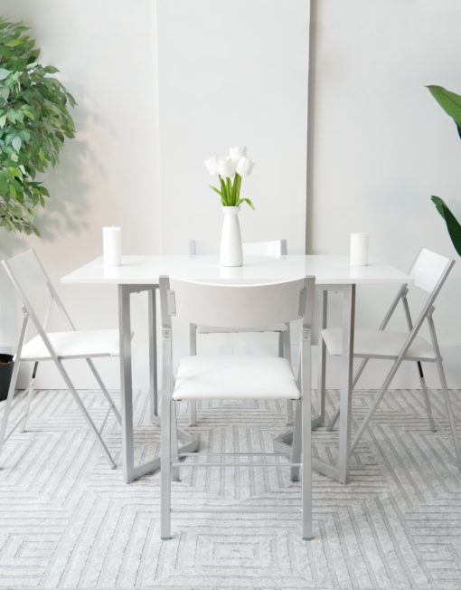 Flip-console-to-table-in-glossy-white-opened-in-dining-form-with-4-nano-chairs-in-a-modern-room-with-grey-carpet-from-side