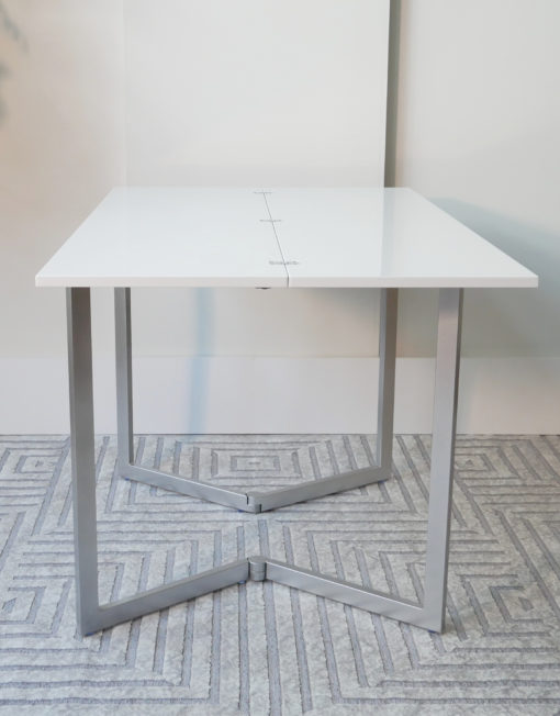 Flip-table-opened-up-with-no-decorations-ready-for-dinner-in-glossy-white