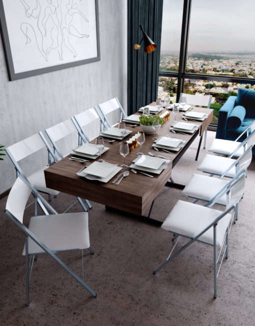 Transforming Box Coffee dinner table in extended form. Chocolate walnut panel finish with table ware decorating table and white nano chairs surround the table