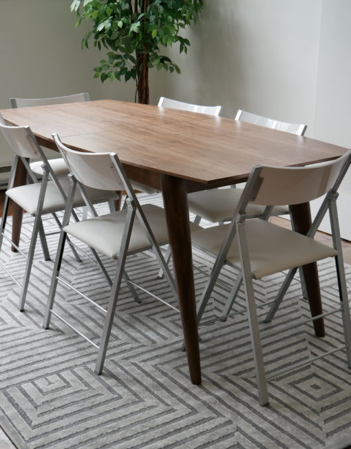 hygge-extending-wood-table-paired-with-white-nano-folding-chairs