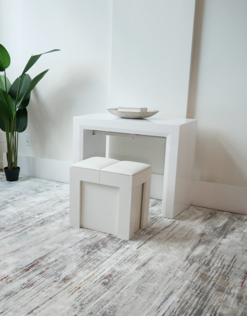 Mini Scatola in white being used as a seat in front of the junior giant white glossy console